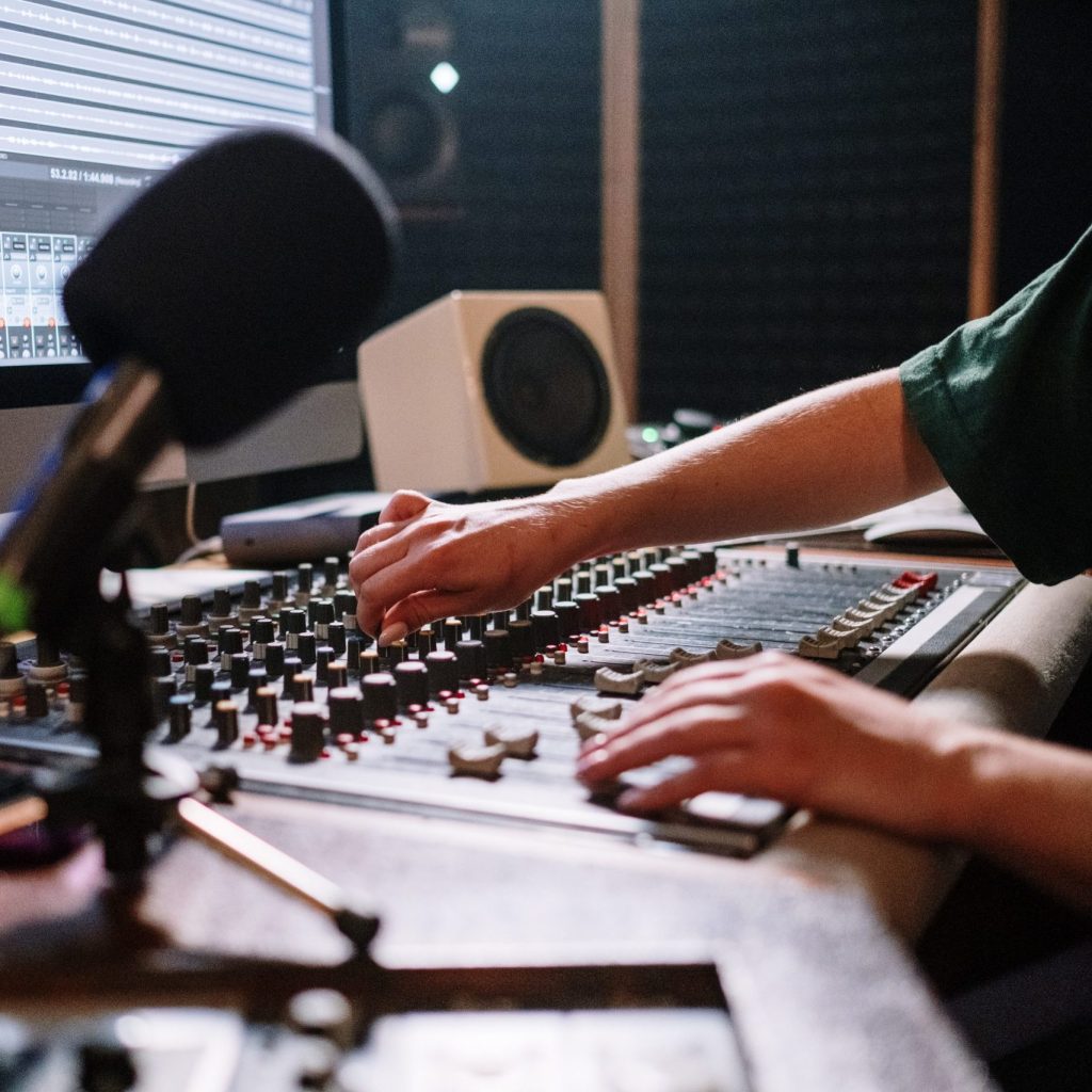 Close-up of hands mixing a track on a mixing desk in Bristol